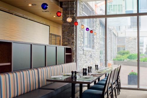 a dining room with a long table and chairs at The Sidney Pier Hotel & Spa in Sidney