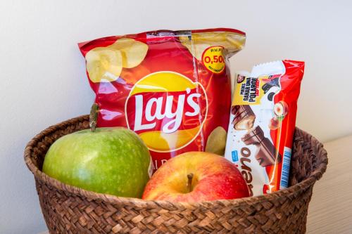 a basket filled with apples and snacks on a table at B&B HOTEL Lisboa Aeroporto in Lisbon