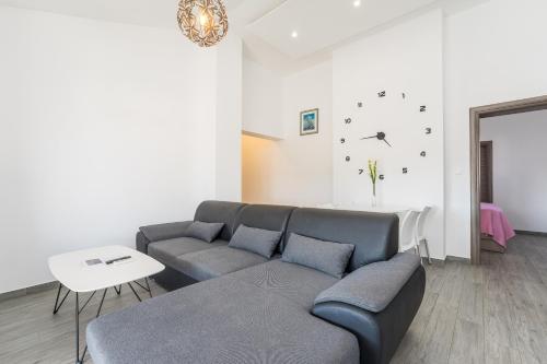 a living room with a couch and a table at Apartments Maza in Zadar