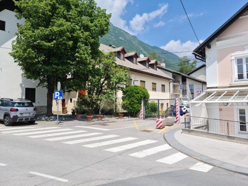 a street with a crosswalk in front of a building at Apartma Dora Bovec in Bovec