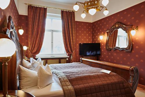 a bedroom with a bed and a mirror and a window at Bernsteinschloss in Wendorf