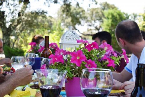 a group of people sitting at a table with flowers at Villa Prana in Avila