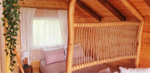 a bedroom with a bed in a wooden cabin at The Treehouse of The Dragon in Ioannina