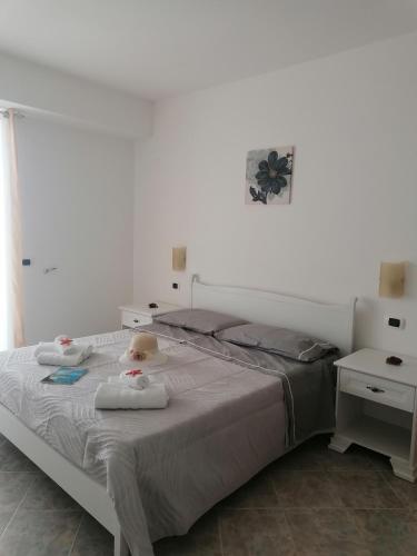 a bedroom with a bed with a teddy bear sitting on it at L'Alba in Tropea