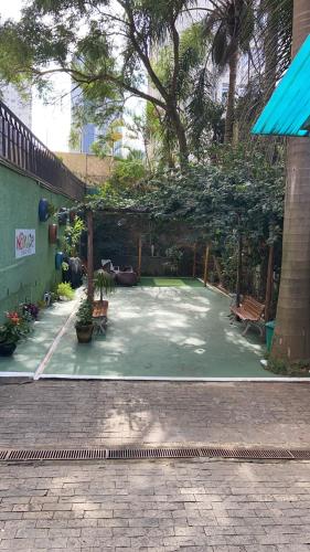 una pista de tenis con bancos encima en Nomade In Arte e Hostel São Paulo, en São Paulo