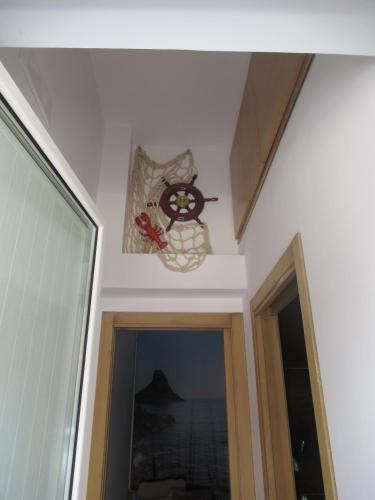 a clock on the wall above a door in a room at Alba Chiara in Acitrezza