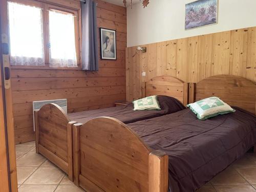 a bedroom with a large wooden bed in a room at M3 in Le Grand-Bornand