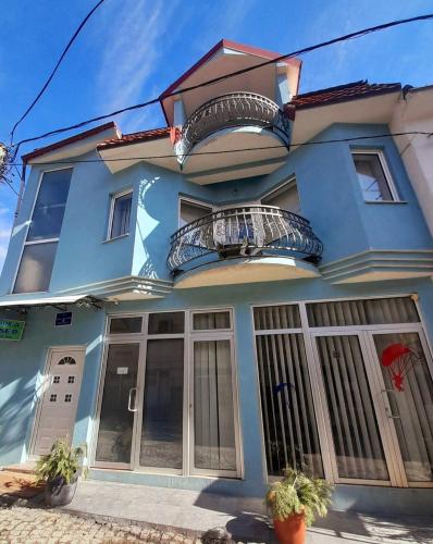 a blue house with two balconies on it at ***Vila Toše D. Kruševo in Kruševo