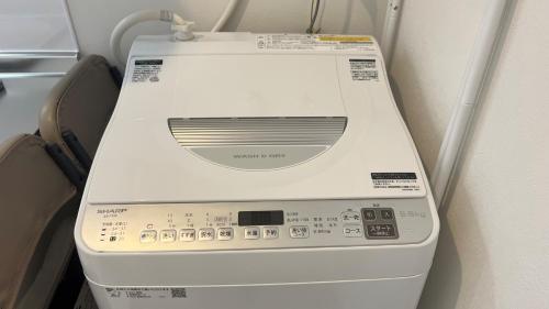 a washing machine in an airplane at Living Inn Nahakoumae in Naha