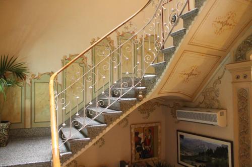 a staircase in a home with a gold railing at Hotel la Vila in Sóller