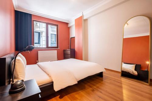 a bedroom with a bed and a mirror at Central Location and a Pleasant Balcony in Maltepe in Istanbul