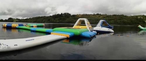 a group of inflatable water slides on a body of water at Corraglass House - close proximity to Cuilcagh in Letterbreen
