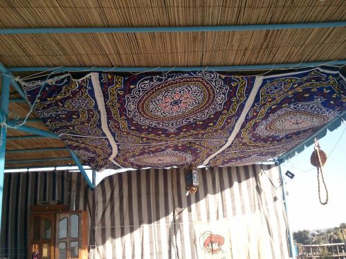 a blanket hanging from the ceiling of a tent at Bet El Kerem Guesthouse in Aswan