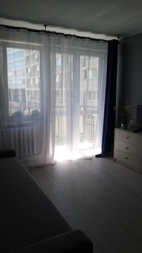 Posteľ alebo postele v izbe v ubytovaní Apartament Wika
