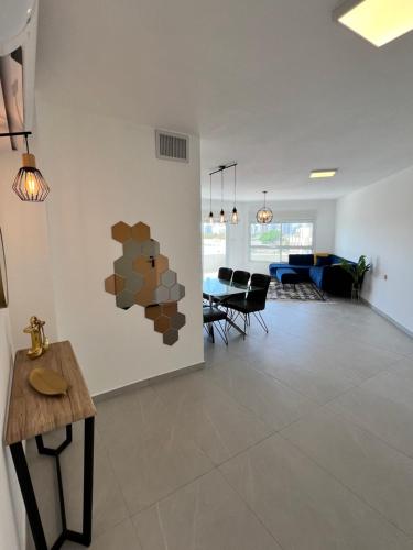 a living room with a table and a dining room at Rothschild Royal in Ashdod