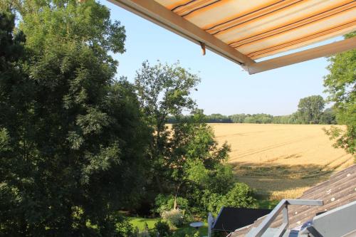 a view of a field from the porch of a house at Haus Sigge Ferienwohnungen in Bad Sassendorf