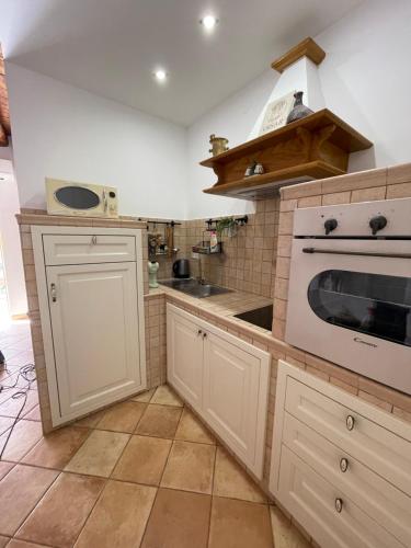 a kitchen with a white oven and a sink at Studio Apartment Ana in Vrsar