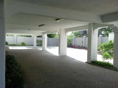 an empty parking lot with white columns in a building at Shanzu Beach apartment with stunning Ocean view in Mwakirunge