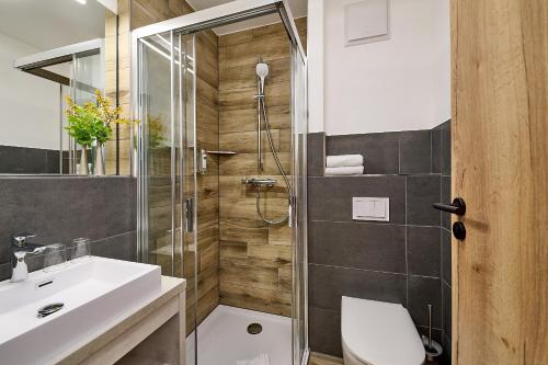 uma casa de banho com um chuveiro, um WC e um lavatório. em R&R Hotel Störtebeker em Baabe