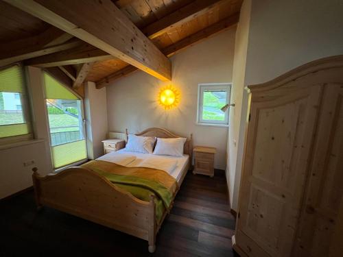 a bedroom with a bed in a room with windows at Armelen Villa in Oetz
