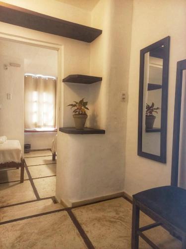 a living room with two potted plants on a wall at Casarão Jeri in Jericoacoara
