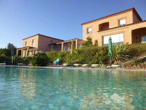 a large pool of water in front of a building at Domaine de Flo ADULT a partir de 16 ans in Saint-Jean-de-la-Blaquière