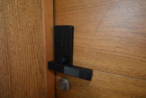 a black door knocker on a wooden door at Atmospheric apartment with a beautiful view of the swimming pool in Bayahibe