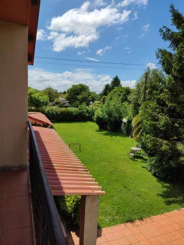 a bench sitting on a balcony with a yard at Twin Pines Camino Norte in Arzúa
