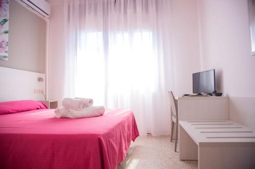 Postel nebo postele na pokoji v ubytování Hotel Laura