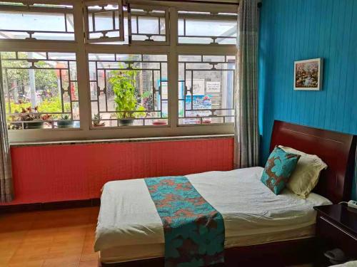 a bedroom with a bed and a window at Beijing Badaling Great Wall Caos Courtyard Hostel 1Private english tour guide 2Pick up&Drof off &landmark visiting serivice3Very near to Badaling Great Wall4Offer free beijing travel guide5Traditonal Chinese courtyard in Yanqing