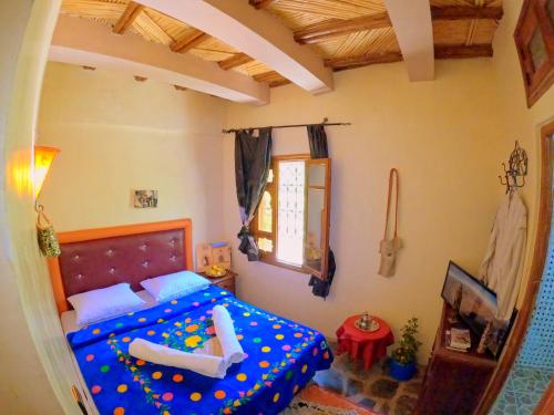 a bedroom with a bed with polka dots at Auberge Atlas Toubkal in Imlil