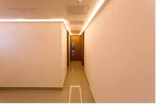 a hallway with a door leading to a room with a wall at Pelican London Hotel and Residence in London