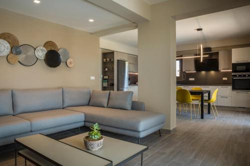 a living room with a couch and a table at Anthélia villa in Kefallonia