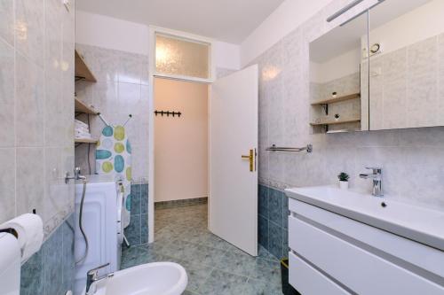 a bathroom with a sink and a toilet at DAIROS2 in Mali Lošinj