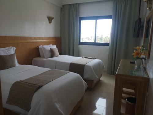 Postel nebo postele na pokoji v ubytování Majliss Hotel Downtown