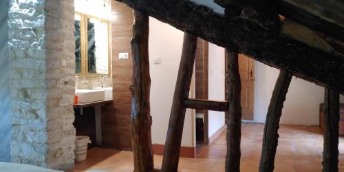 a room with a staircase leading to a bathroom at Albergue El Condor in Paúles