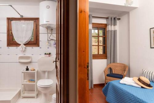 a bathroom with a bed and a toilet in a room at Seaside House with view over Pagasitikos in Afissos