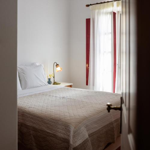 a bedroom with a bed and a window at Nikos Villas in Oia