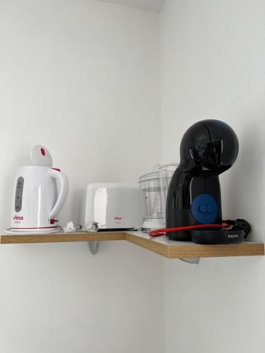a shelf with various kitchen appliances on it at Casa rural con baño adaptado y piscina en Mogán in Mogán
