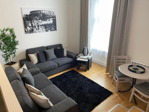 a living room with a couch and a table at Heart of George Street 2 in Oban