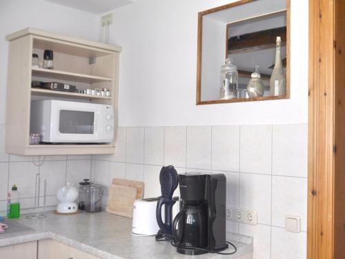 a kitchen counter with a coffee maker and a microwave at Ferienwohnungen im Gewölbe in Wismar