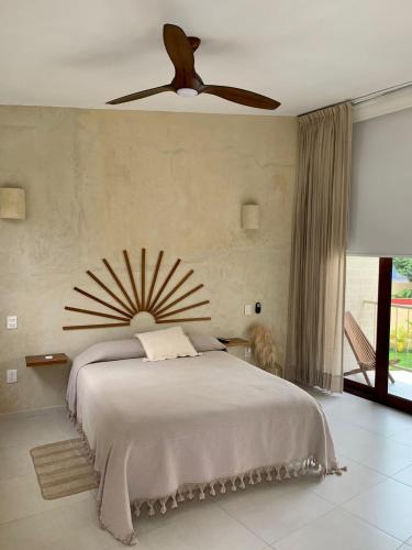 a bedroom with a bed with a ceiling fan at La Bohème Sayulita in Sayulita
