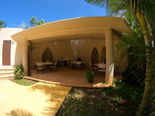a patio with tables and chairs in a house at Azcapri Villa Boutique & Spa in Cancún
