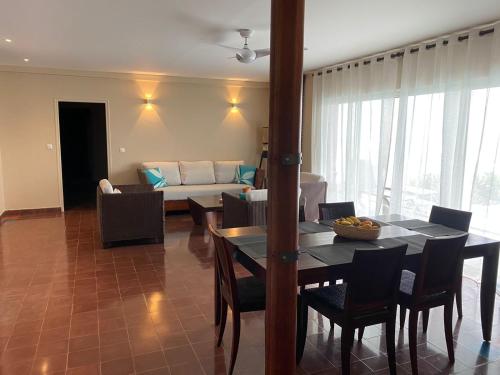 a living room with a table and a couch at Les Villas du Lagon in Le François