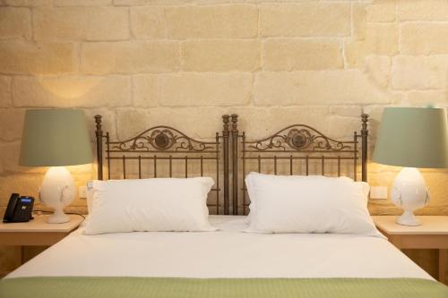 Ένα ή περισσότερα κρεβάτια σε δωμάτιο στο MASSERIA LILEI