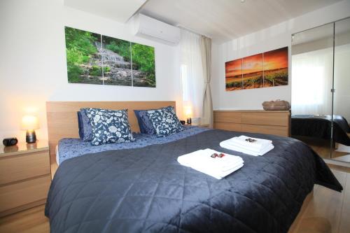 a bedroom with a bed with two towels on it at Paskal-Lux Apartments with Free Parking and AC in Budapest