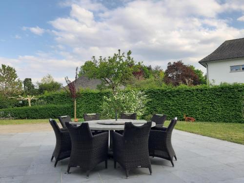 a table and chairs sitting around a patio at Ruime woning met grote omheinde tuin in Hasselt