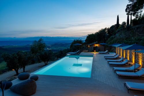 a swimming pool with lounge chairs and a resort at Antichi Casali di Charme in Orvieto