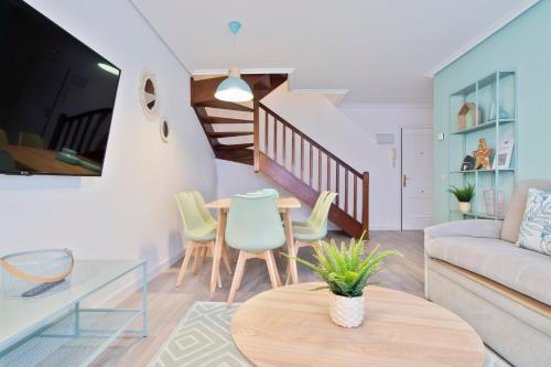 a living room with a table and chairs at Abba Comillas Apartments in Comillas