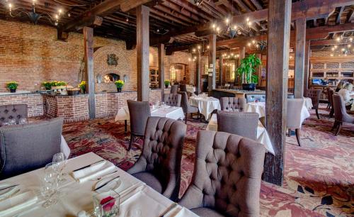 um restaurante com mesas e cadeiras em uma sala em WeatherPine Inn em Niagara on the Lake